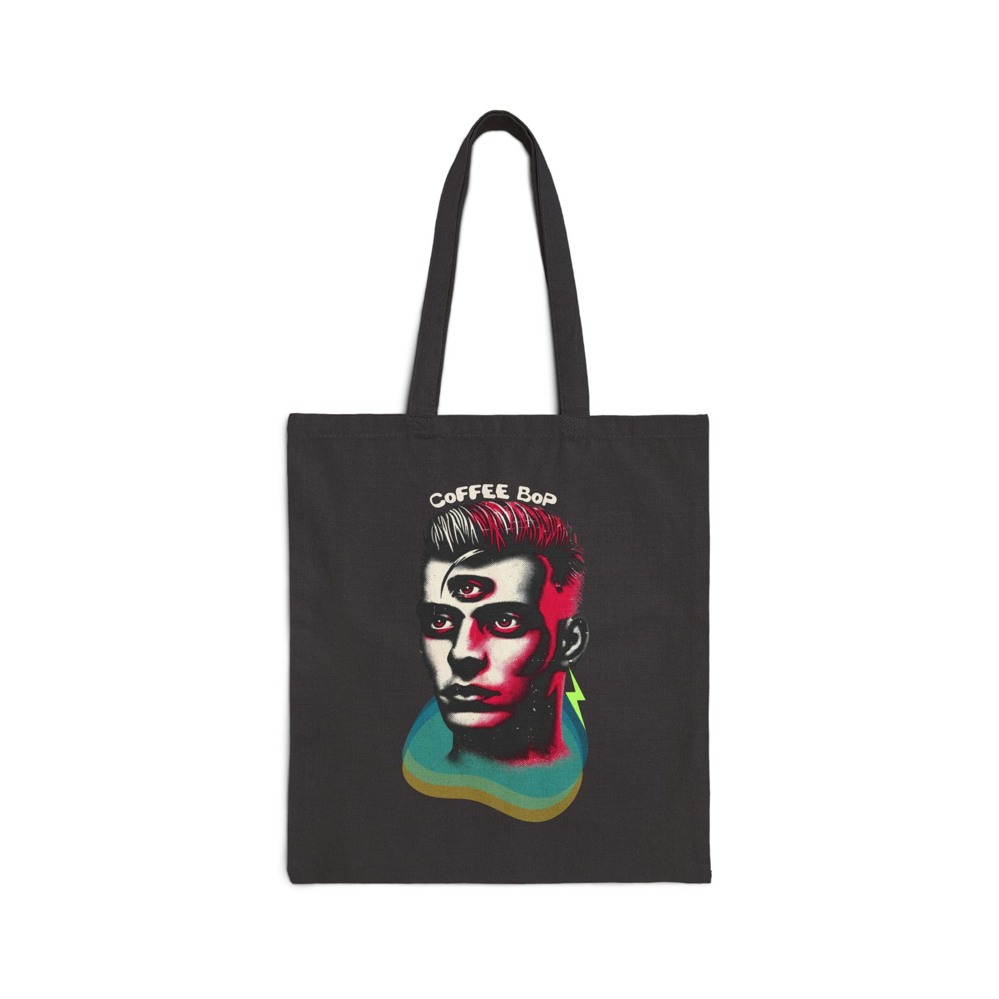 Black canvas tote bag featuring a surreal, high-contrast illustration of a third-eye punk visionary, blending 80s goth, glam rock, and new romantic aesthetics. Bold typography reads "Coffee Bop," adding a rebellious edge.